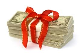 A photograph of a bundle of cash with a bow tied around it. A photograph of a bundle of cash with a bow tied around it.